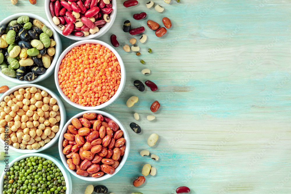 Legumes, shot from the top on a blue background with copy space Legumes, shot from the top on a blue background with copy space