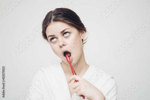 morning procedures brushing teeth emotional Woman in a white robe