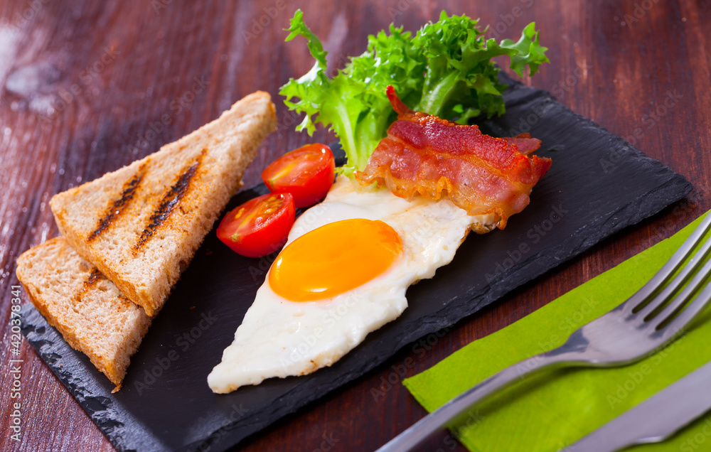 Tasty Breakfast From Fried Egg Bacon And Grilled Bread Served With Tasty Breakfast From Fried Egg Bacon And Grilled Bread Served With