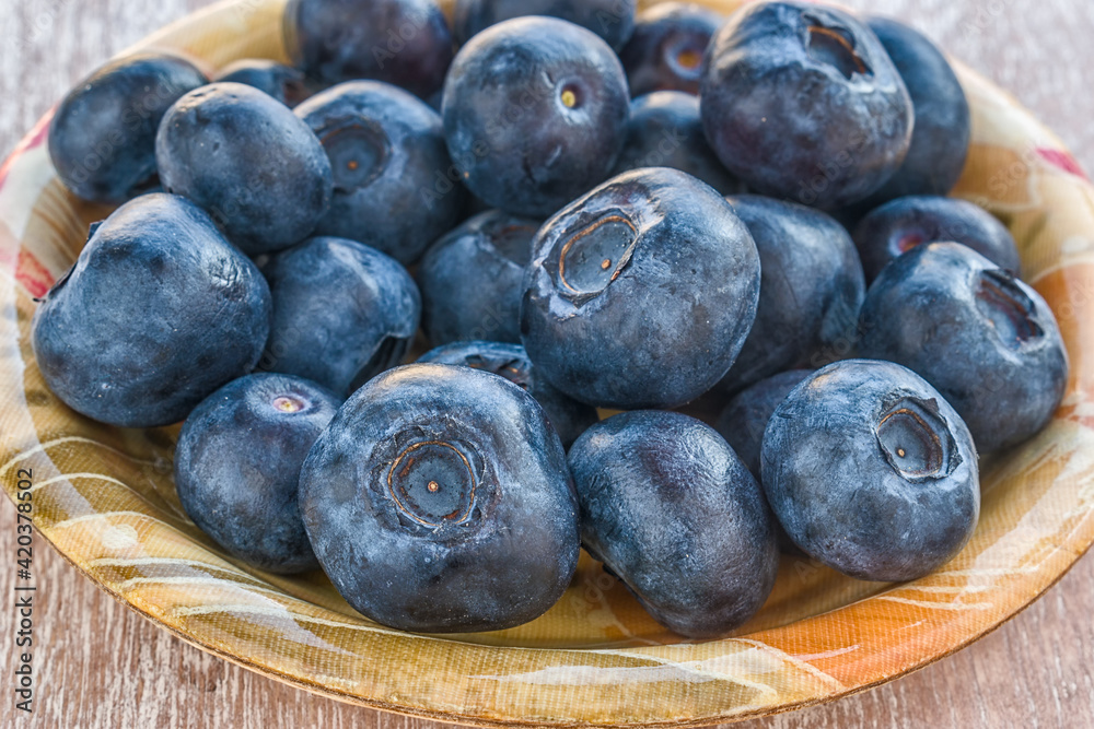Fototapeta premium Fresh blueberries in a bowl. Close view.