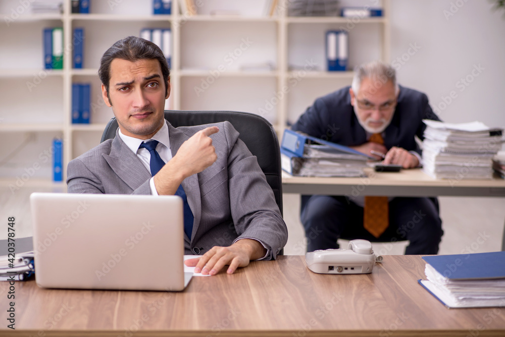 Two employees sitting at workplace Two employees sitting at workplace