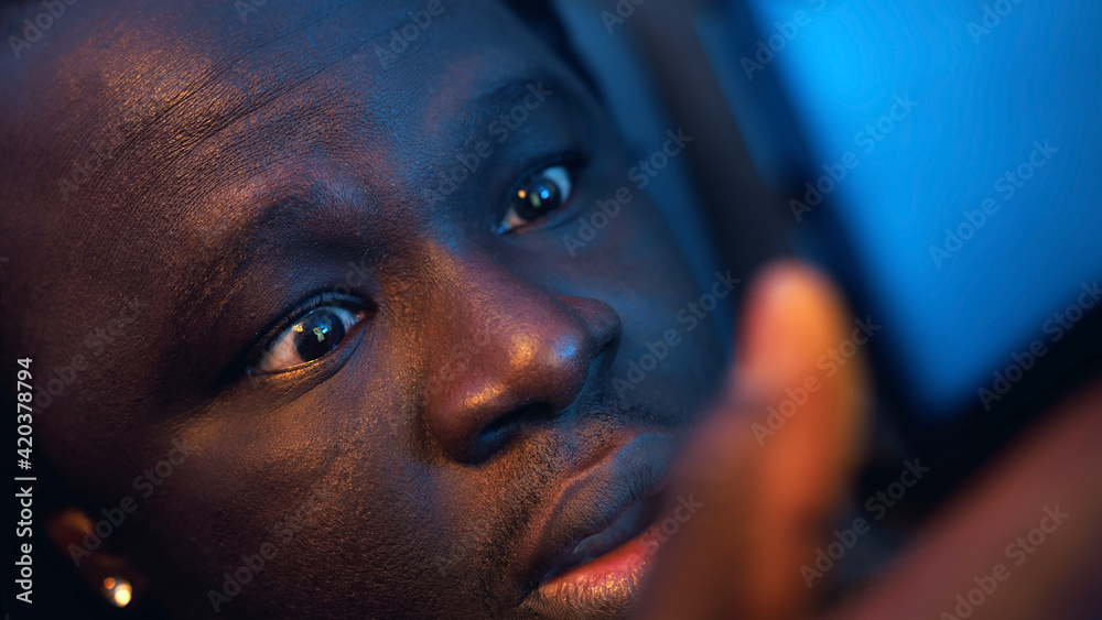 Shocked african american black man reading email wrapped in blanket. Bad news. High quality photo Shocked african american black man reading email wrapped in blanket. Bad news. High quality photo