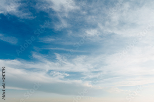 Beautiful blue sky with stretched white clouds
