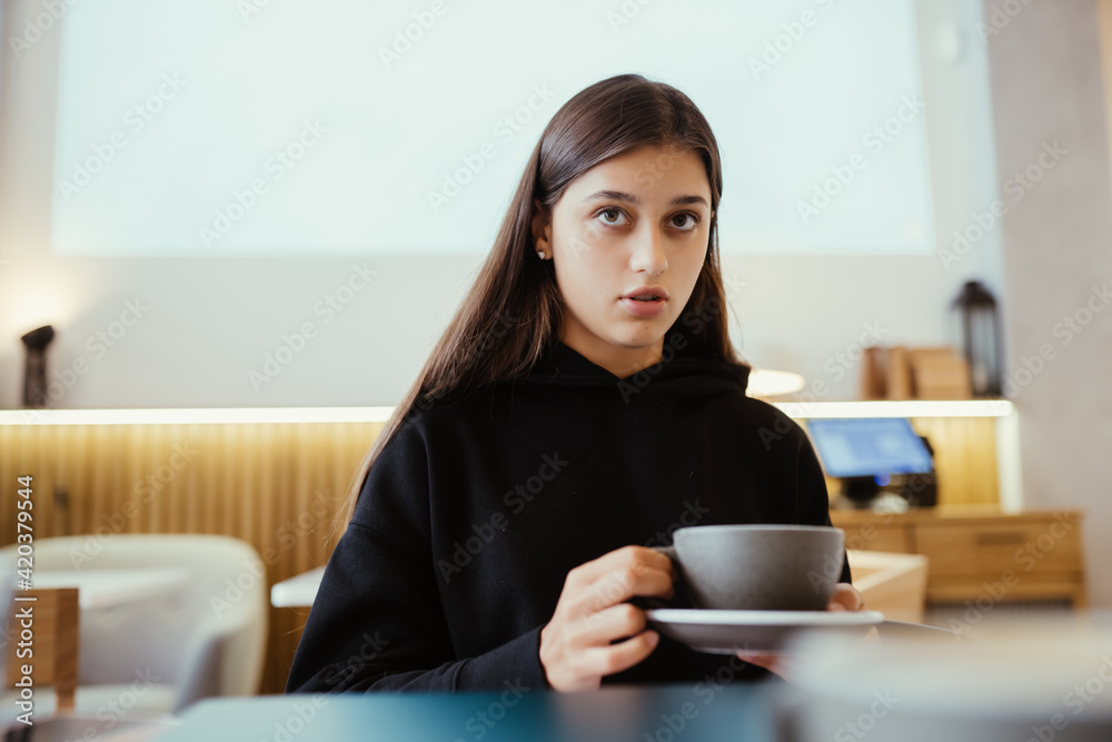 Portrait of a young beautiful women drinking coffee in cafe Portrait of a young beautiful women drinking coffee in cafe