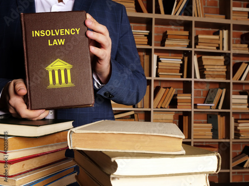 Photos INSOLVENCY LAW book in the hands of a attorney