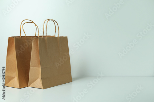 Blank paper bags on white background, space for text
