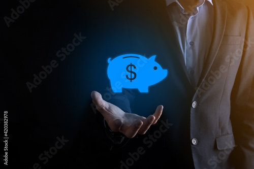 Businessman hold piggy bank icon .Business and Money spending planning, and investment budget, Business saving money concept.save or investment