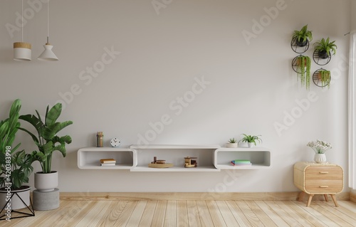White wall living room with a TV table  hanging lamps and trees on the floor beside it.3d rendering.