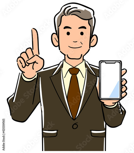 スマートフォンを手に持ち人差し指をたてるスーツ姿の管理職男性
