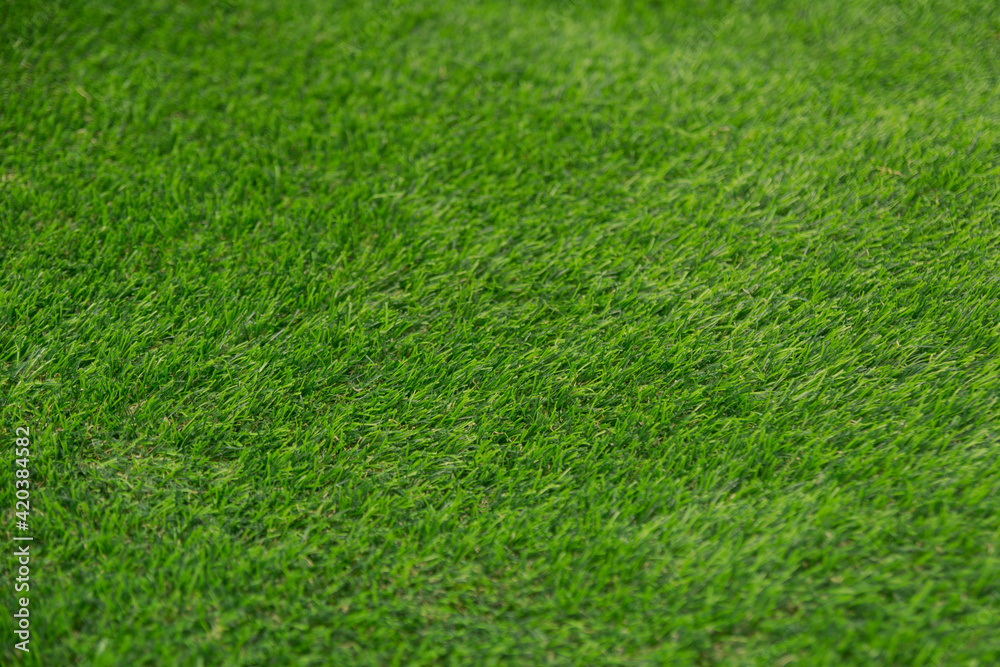 Closeup green artificial grass selective focus.