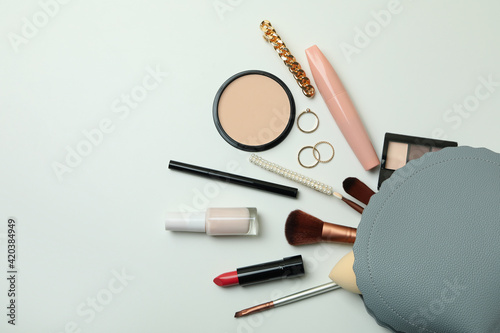 Cosmetic bag with cosmetics on white background