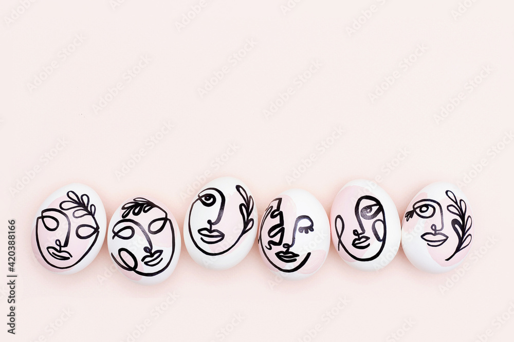 Happy Easter concept. Surreal faces on eggs on pink background. Art und Online style. Top view Flat lay Copy space Happy Easter concept. Surreal faces on eggs on pink background. Art und Online style. Top view Flat lay Copy space