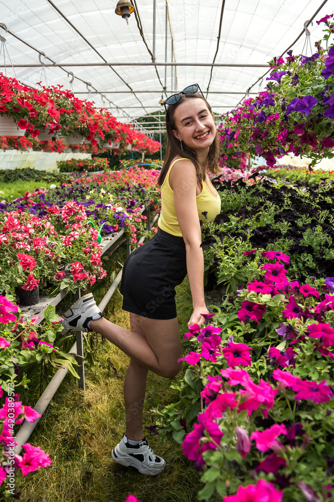 portrait of a beautiful young woman in flower greenhouse portrait of a beautiful young woman in flower greenhouse