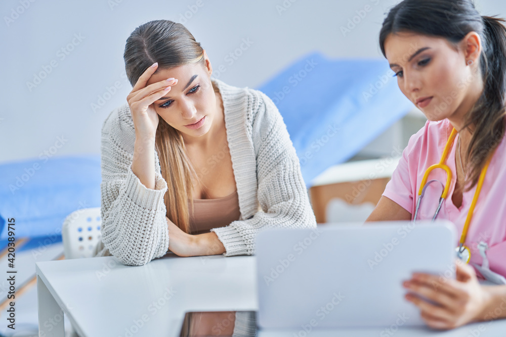 Doctor explaining diagnosis to her female patient Doctor explaining diagnosis to her female patient
