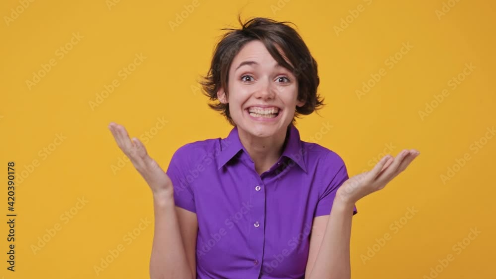 Side profile view surprised fan brunette short hairdo young woman 20s years old in pink violet shirt turn around camera cover mouth with hands doing winner gesture isolated on yellow background studio Side profile view surprised fan brunette short hairdo young woman 20s years old in pink violet shirt turn around camera cover mouth with hands doing winner gesture isolated on yellow background studio