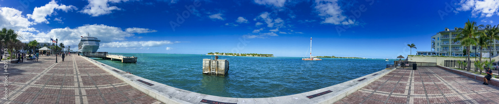 KEY WEST, FL - FEBRUARY 2016: Key West promenade along the ocean with city port on a sunny winter day
