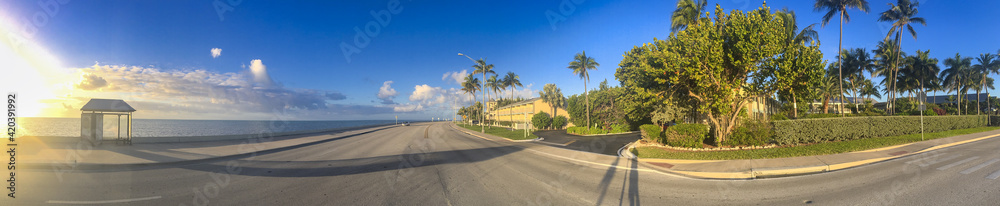Road along the coastline in Key West, Florida. Sun setting with long shadows