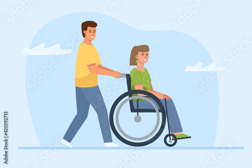 A man is pushing a wheelchair with a pretty young woman. A disabled person date.