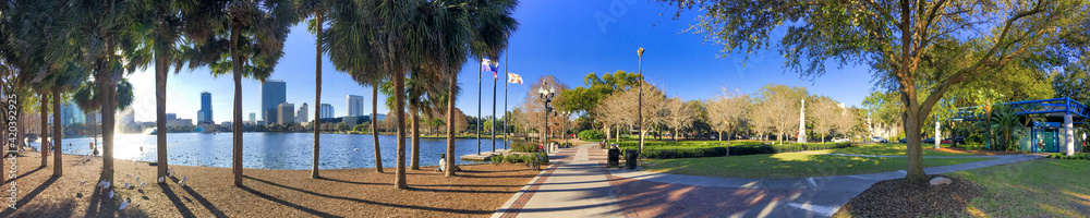 Orlando, Florida. Park along Lake Eola and city skyline at winter sunset