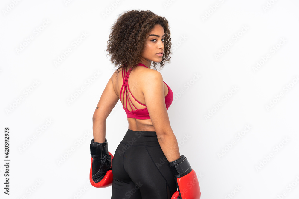 Young African American sport woman isolated on white background with boxing gloves Young African American sport woman isolated on white background with boxing gloves