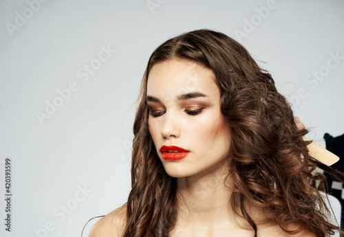 Woman with curly hair make-up eye shadow on the eyelids hairdresser hairstyle