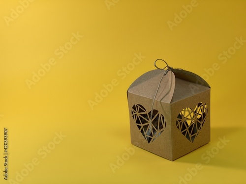 cotton flower packed in a gift box with hearts on a yellow background