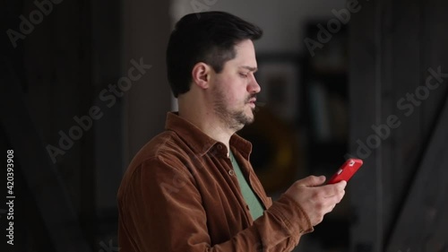 man answers an unknown phone call at home