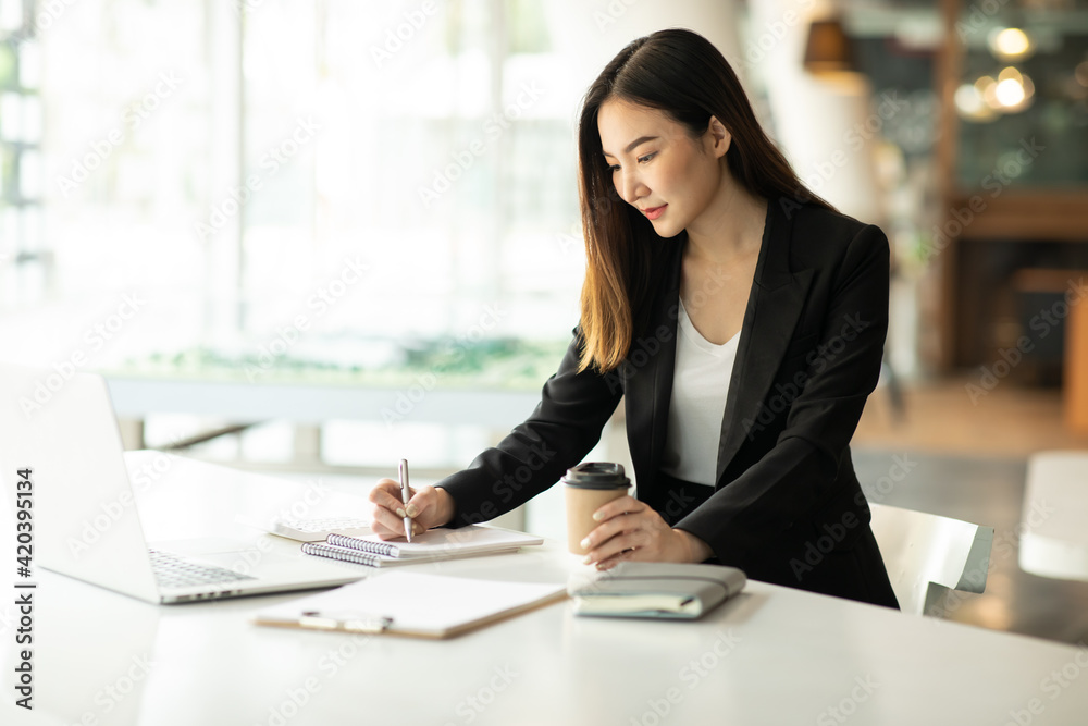Asian young Business woman working in office with documents Asian young Business woman working in office with documents