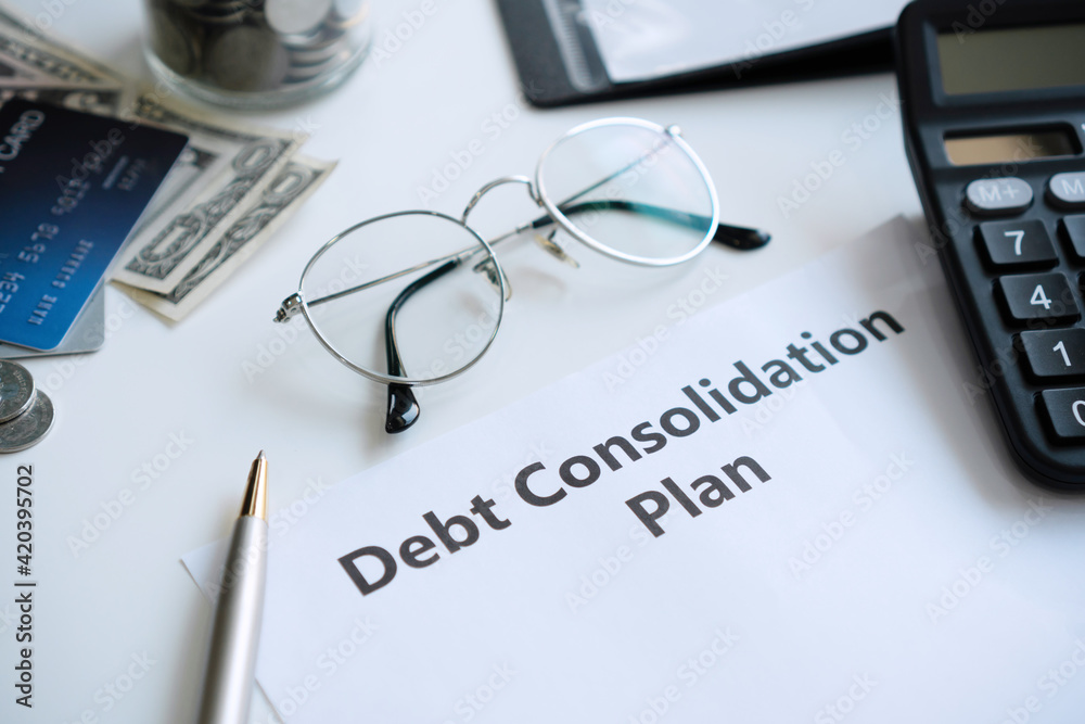 Flat lay of debt consolidation plan in paper on desk with copy space, top view. Flat lay of debt consolidation plan in paper on desk with copy space, top view.