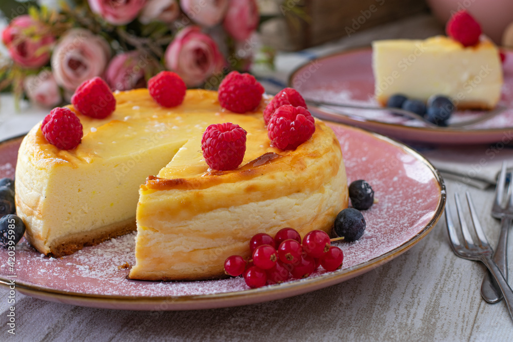 Cheesecake with raspberries on a table Cheesecake with raspberries on a table