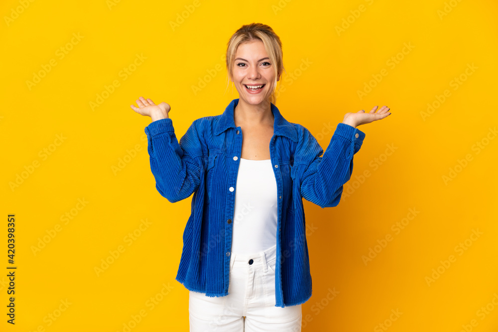 Young Russian woman isolated on yellow background with shocked facial expression Young Russian woman isolated on yellow background with shocked facial expression