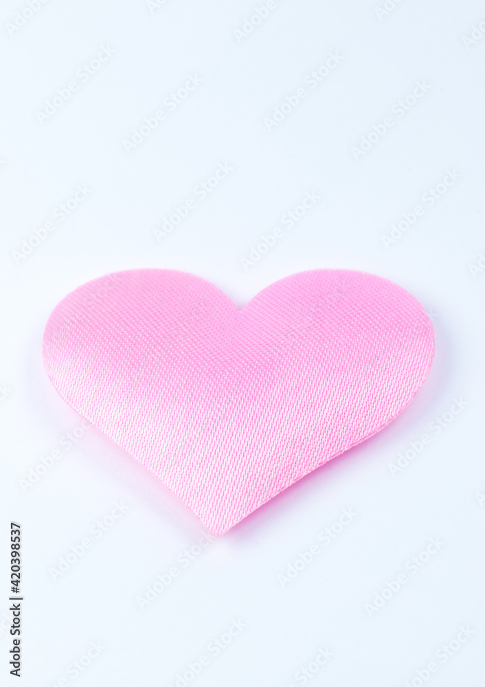 Pink heart on white background. Saint Valentine's day concept. Love and romantic photo. Postcard for holiday. Beautiful warm wallpaper with love. Soft focus. Copy space.