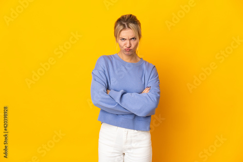 Young Russian woman isolated on yellow background feeling upset © luismolinero