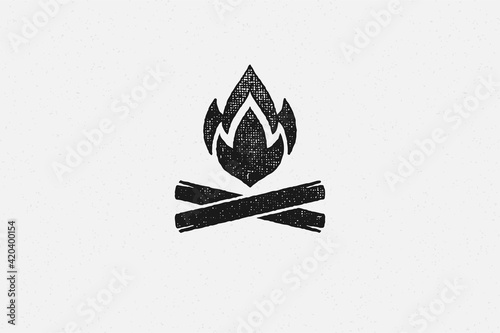 Fotografija Silhouette of hot campfire burning on logs on campsite hand drawn stamp effect v
