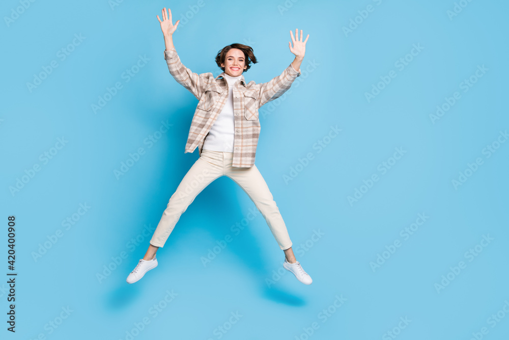 Profile full size photo of optimistic cool lady jump wear shirt trousers sneakers isolated on teal color background