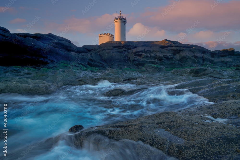 Motion blur Crashing waves and Sunset clouds over Elie, Fife, Scotland.