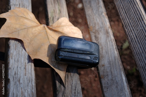 pager, old vintage beeper. the pager lies on a park bench photo