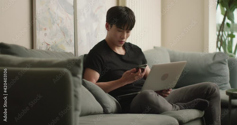 Young Chinese man using laptop at home,4K Young Chinese man using laptop at home,4K
