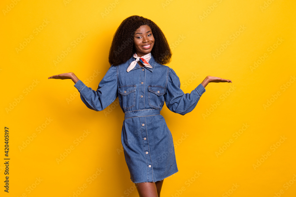 Photo of attractive dark skin lady arms palms hold demonstrating vs scales isolated on yellow color background