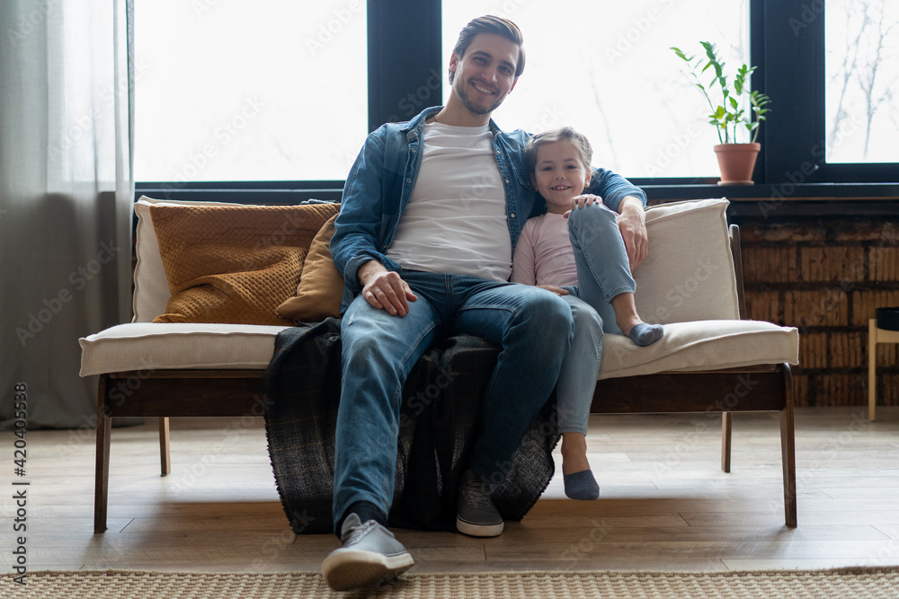 Portrait of handsome father and his cute daughter hugging and smiling. Portrait of handsome father and his cute daughter hugging and smiling.