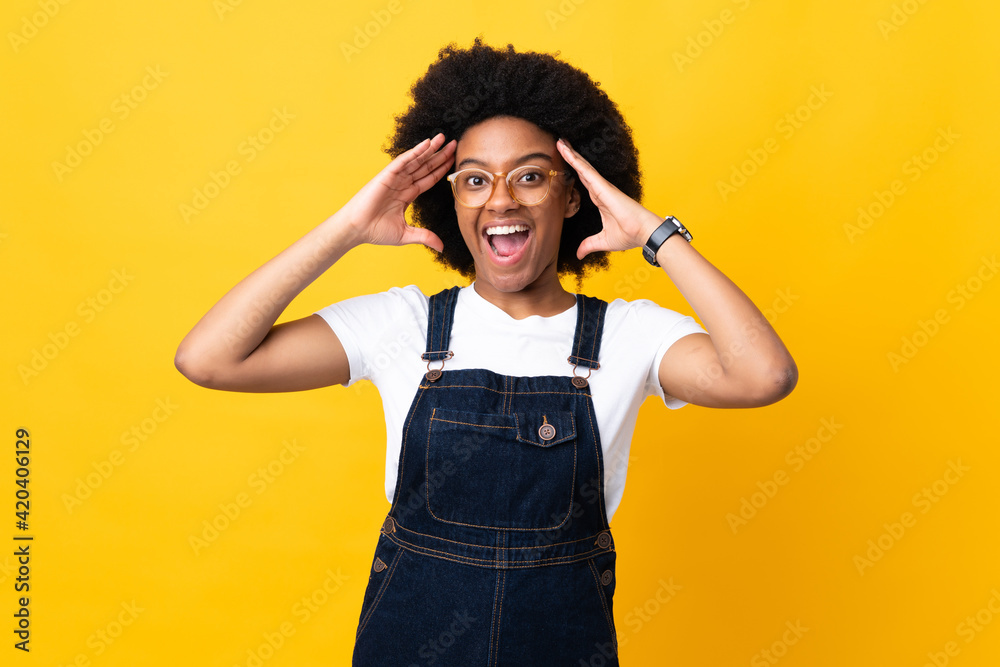 Young African American woman isolated on yellow background with surprise expression Young African American woman isolated on yellow background with surprise expression