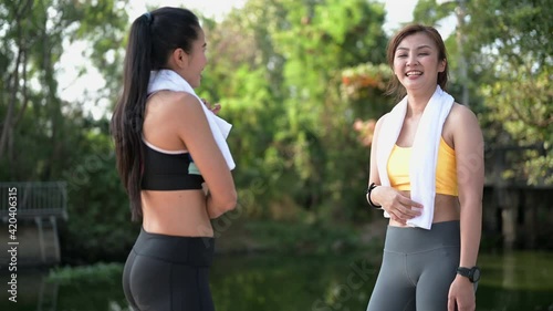 Two Asian female runners jogging in the park