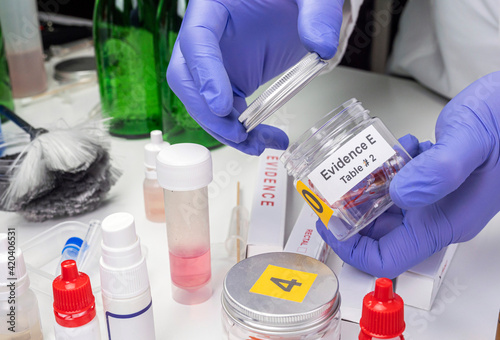 Blood-stained glass sample in an evidence jar, concept image photo