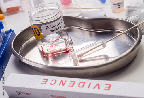 Blood-stained glass sample in an evidence jar, concept image photo