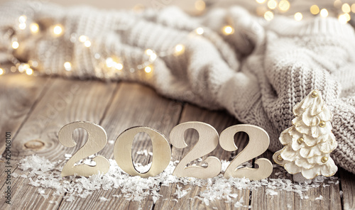 Cozy holiday composition with the numbers 2022 on a blurred background in bokeh.