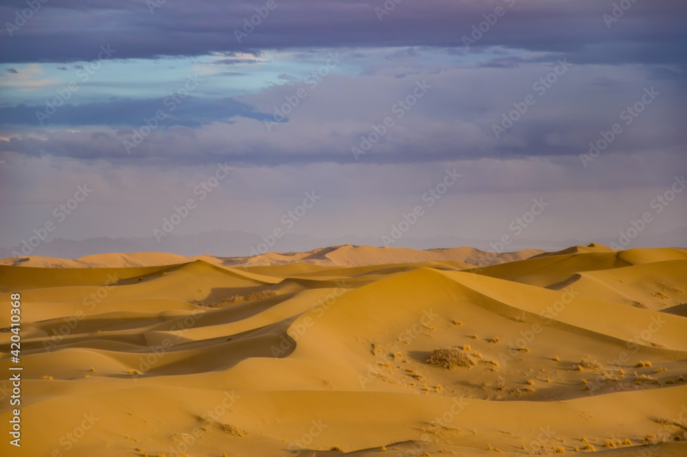 Varzaneh sand dunes at sunset with beautiful purple clouds, Iran