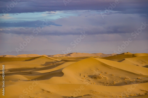 Varzaneh sand dunes at sunset with beautiful purple clouds, Iran