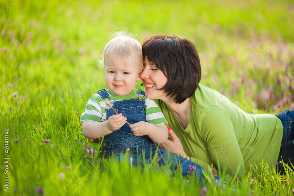 Happy woman and child in the blooming spring garden. Happy woman and child in the blooming spring garden.