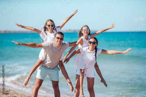 Happy family on the beach during summer vacation