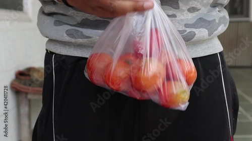red tomatoes. farmer market outdoor. Organic vegetables, small local farm, farming concept. Farmer selling fresh crops, tomato harvest.